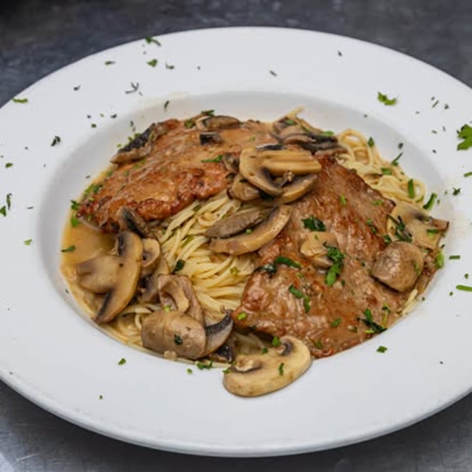 Mushroom cutlets over spaghetti.