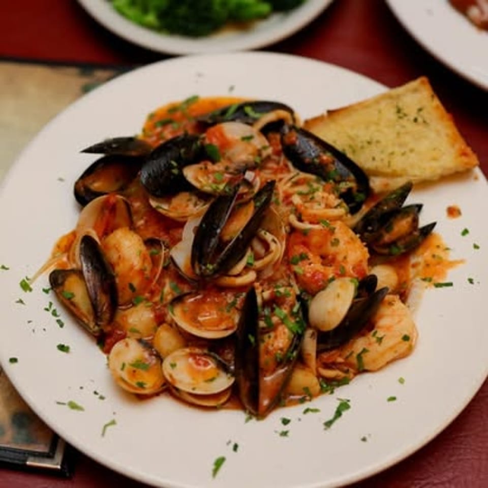 Seafood pasta with mussels, clams and toasted bread.