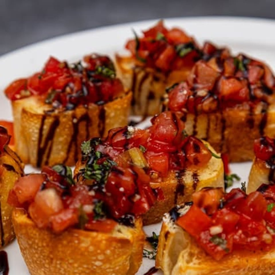 Bruschetta topped with tomatoes and basil.
